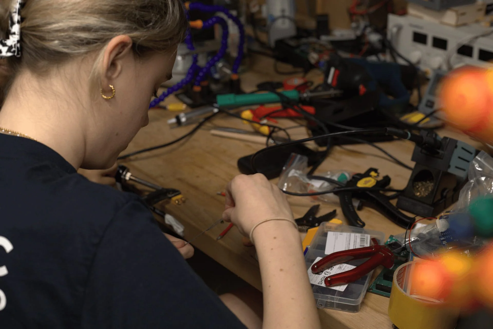Avionics member working on electronics at a bench