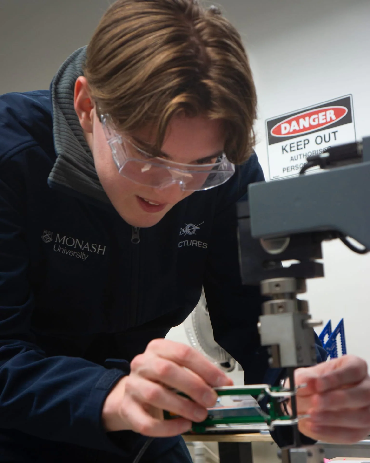 Aerostructures member checking hardware in the workshop